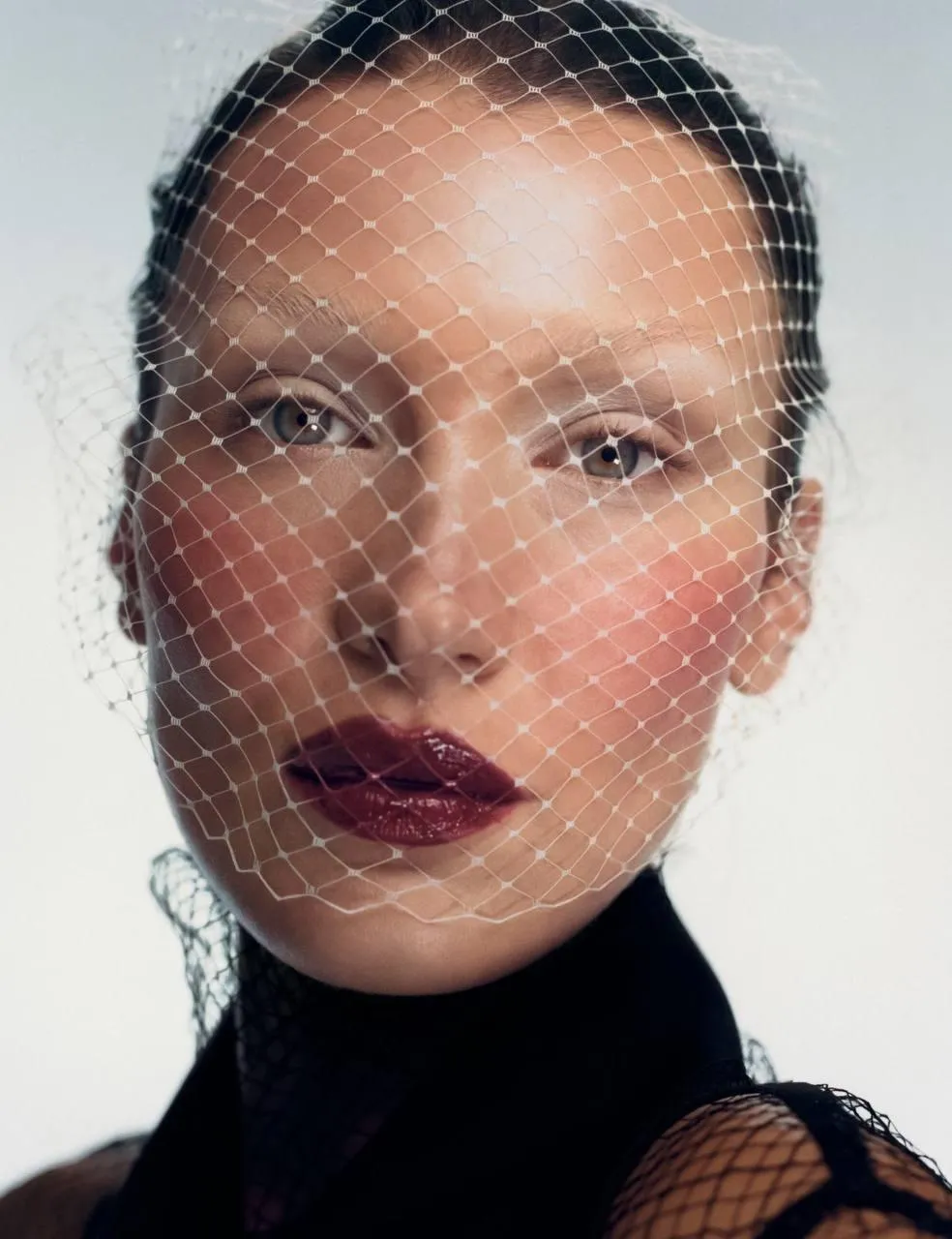 Fashion Portrait of Woman in Netted Veil with Bold Lipstick