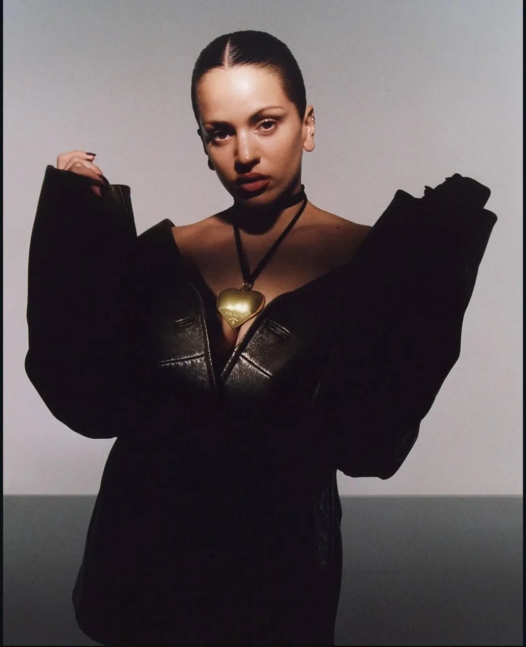 Fashion pose of woman in black off shoulder oversized outfit