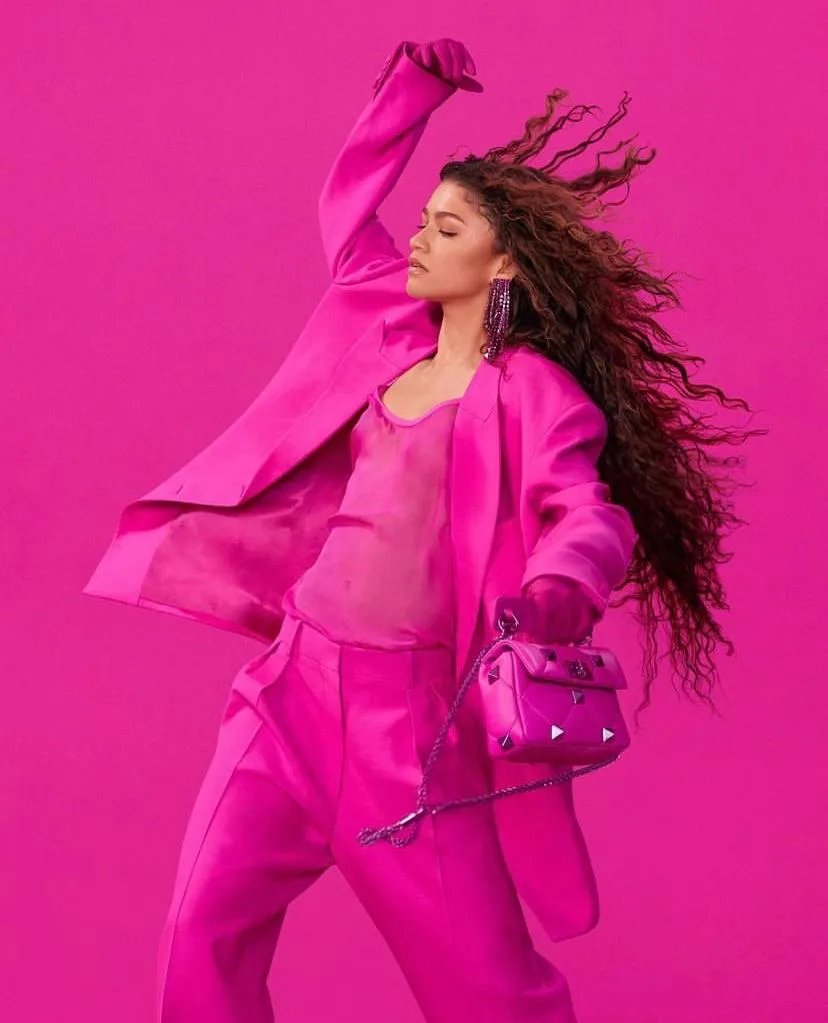 Fashion woman in a pink outfit posing with bold energy image