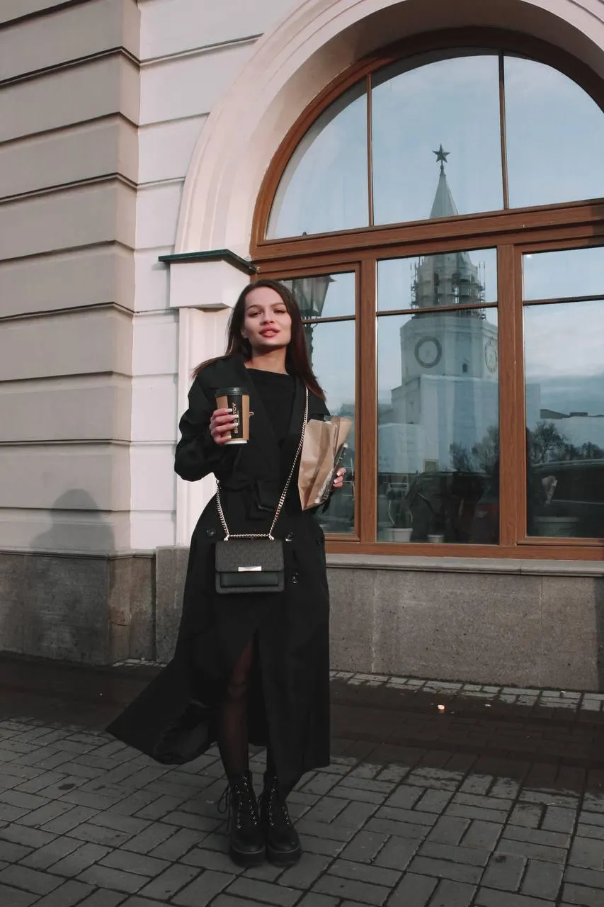 Fashionable Woman Walking City Street Wearing a Black Outfit