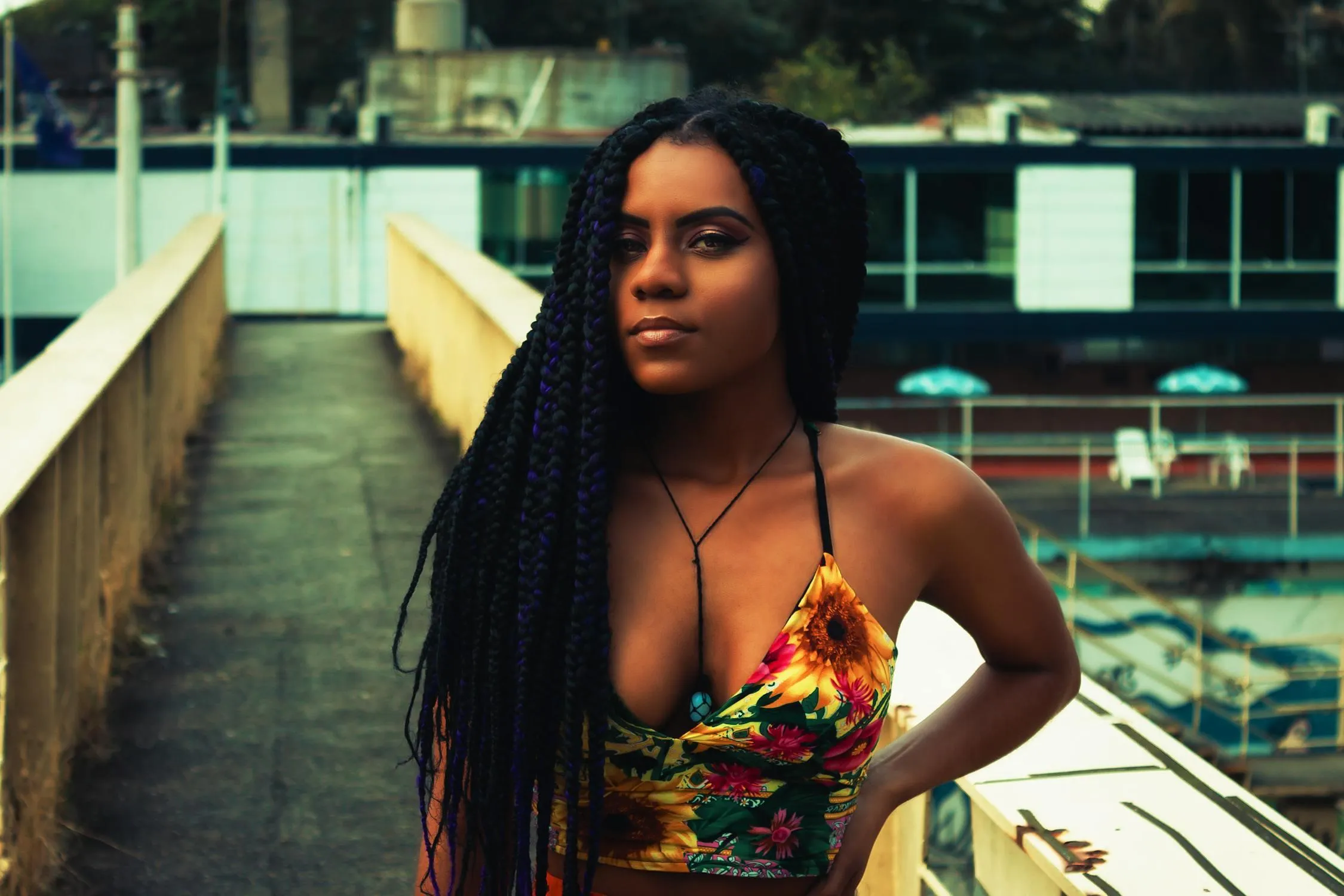 Female Model with Braids Sitting Outdoors on Stone Stairs