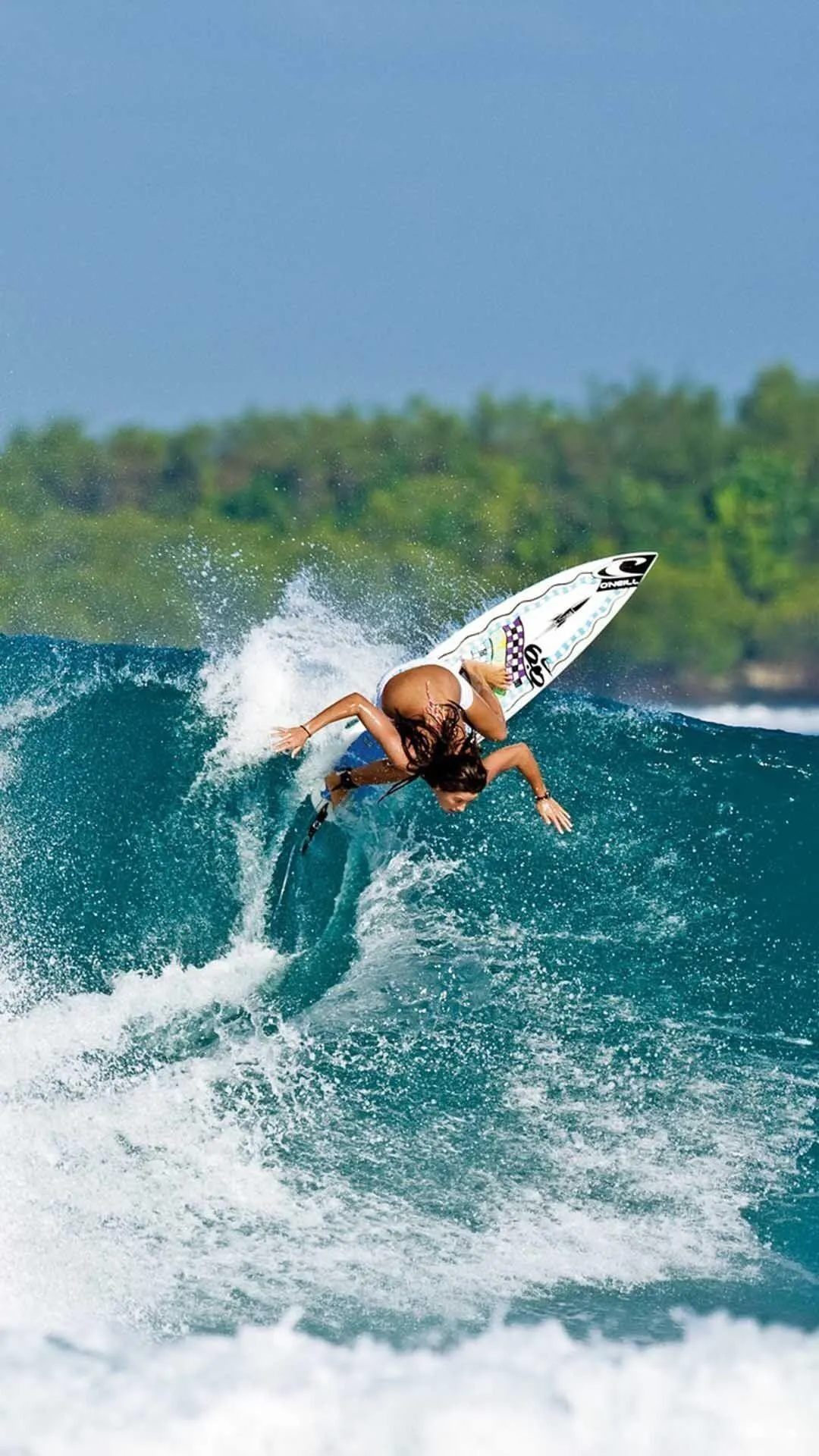 Female Surfer Catching a Wave in Tropical Blue Waters Image