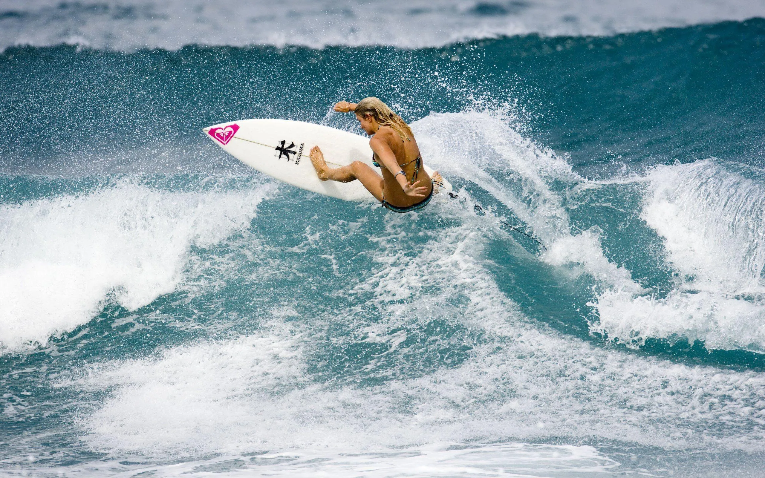 Female Surfer Catching a Wave with Strength And Style Image