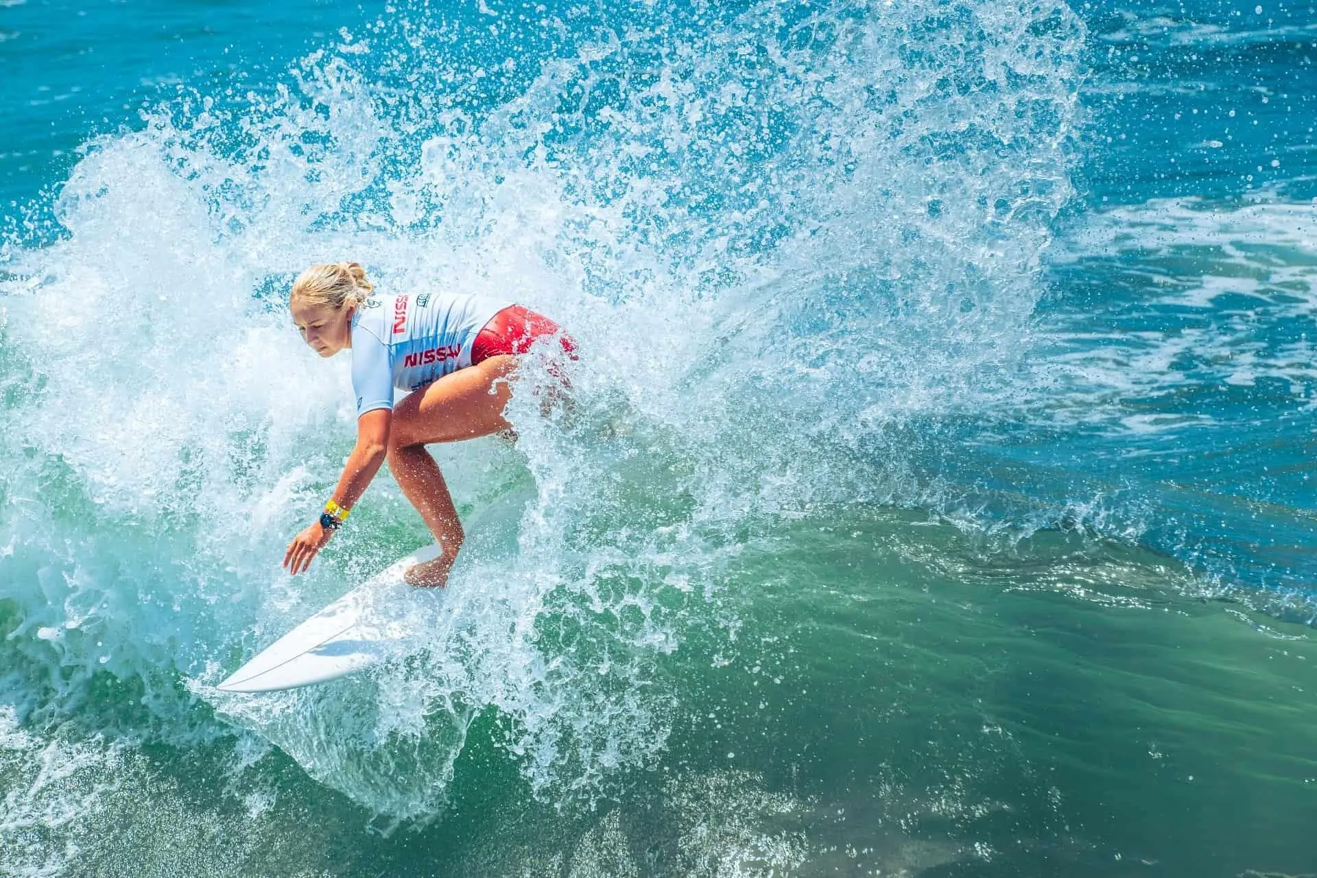 Female Surfer Making a Sharp Turn on a Foamy Wave Crest