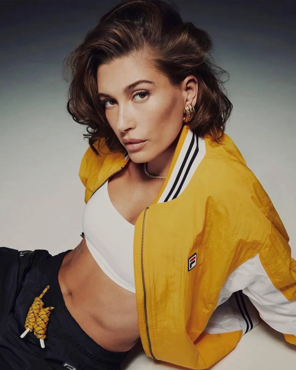 Fitness Model Posing in a Yellow Jacket And White Sports Bra