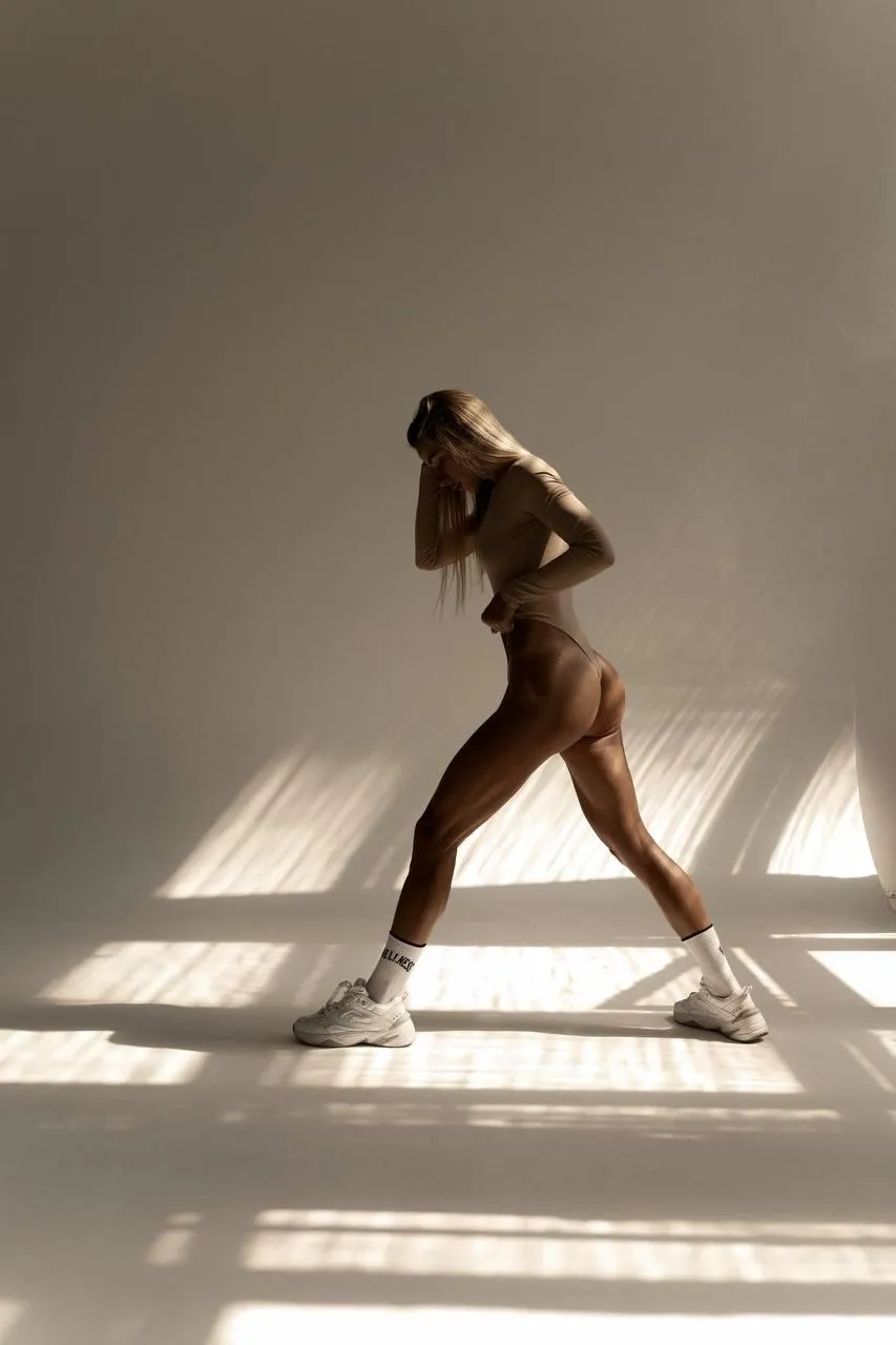 Fitness model stretching in natural light free wallpaper