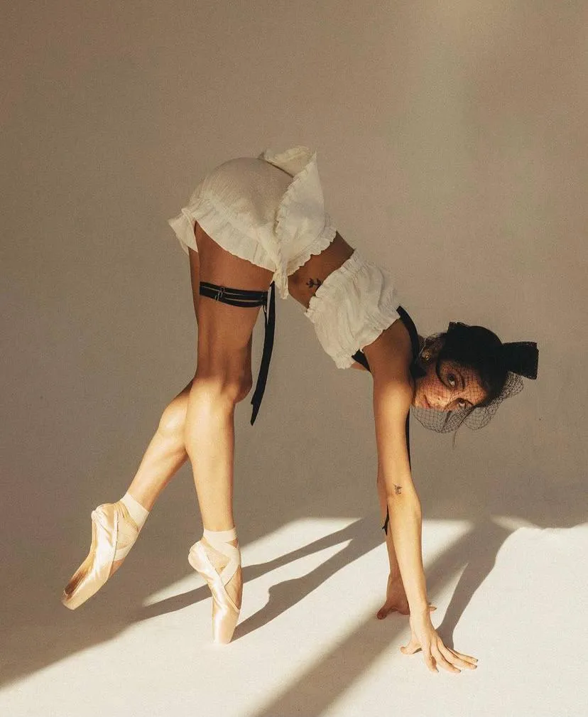 Flexible model in heels bending forward with a dynamic pose