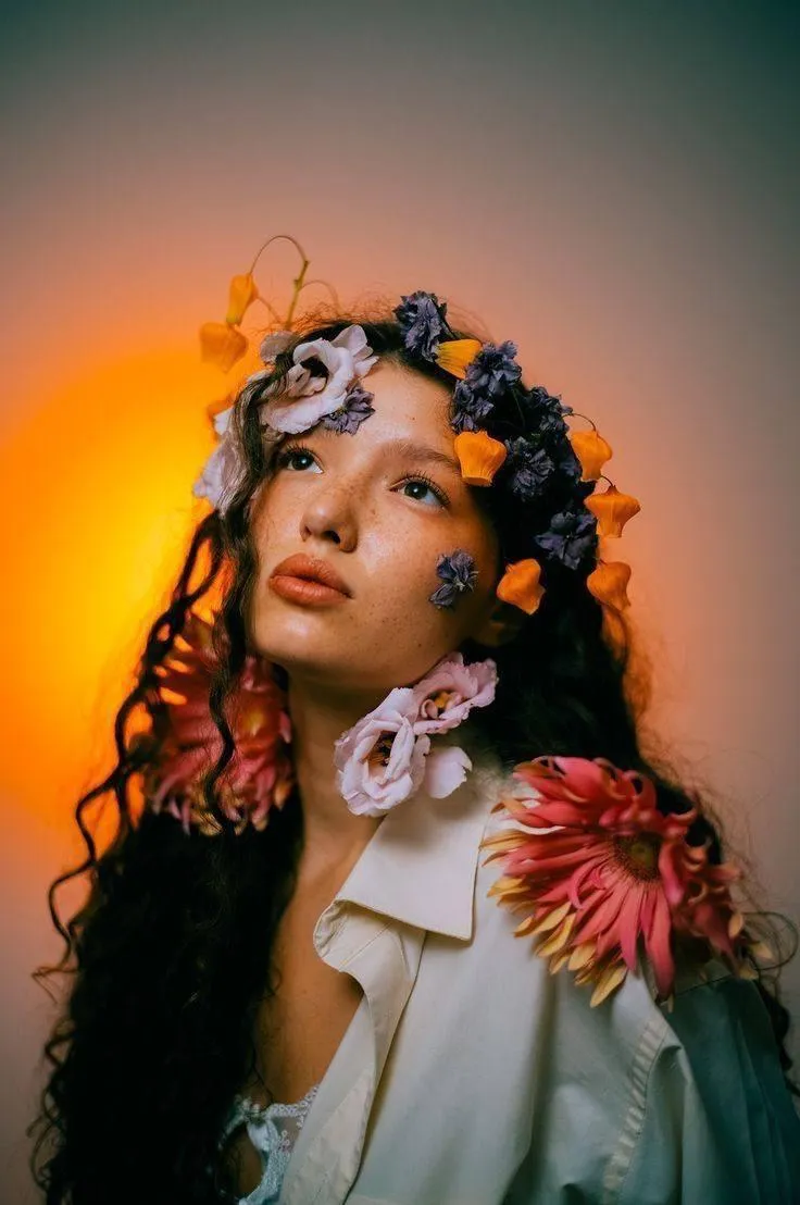 Floral headpiece worn by the model in soft dreamy lighting