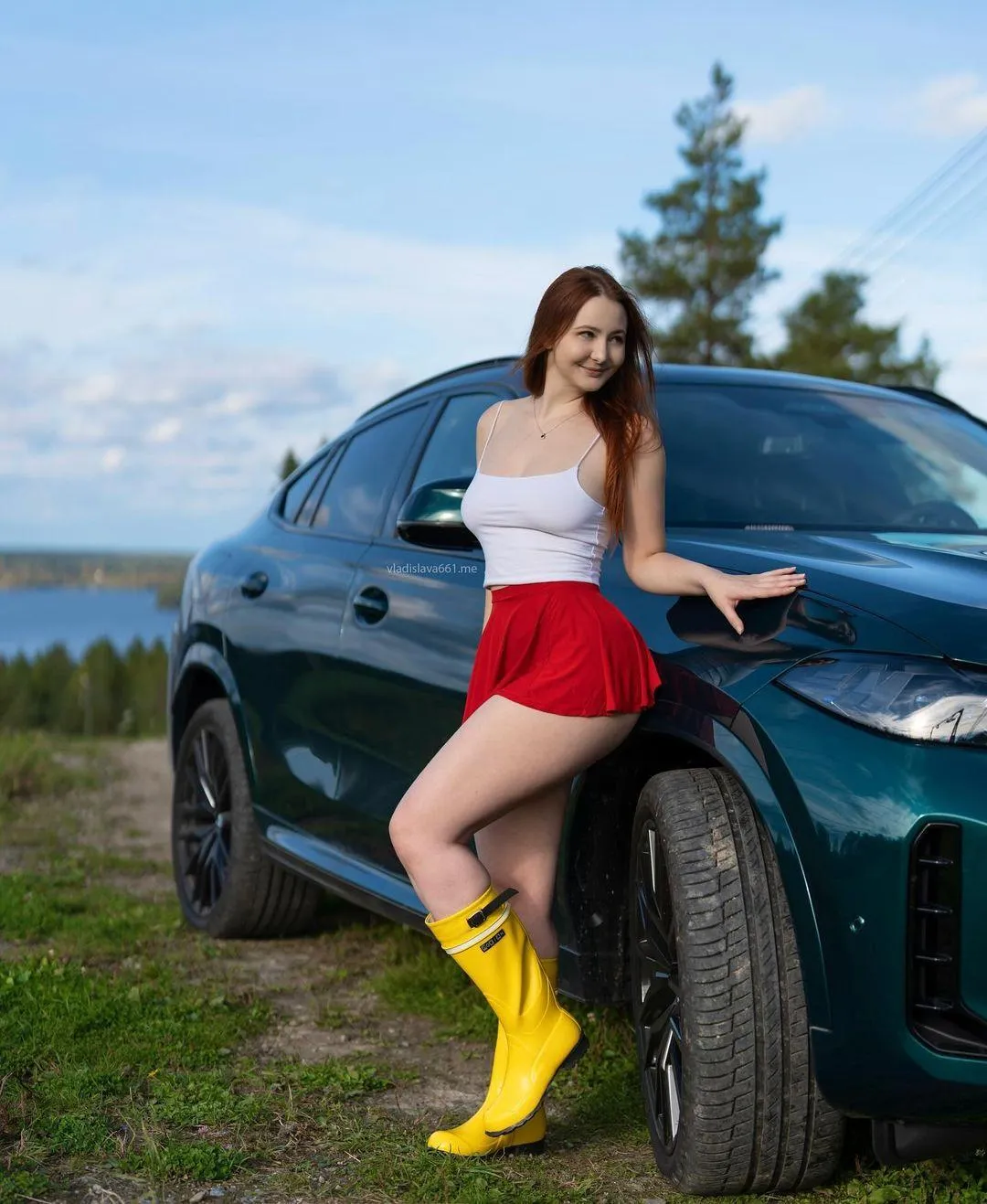 Girl Leaning Against a Blue Car Wearing Yellow Rain Boots