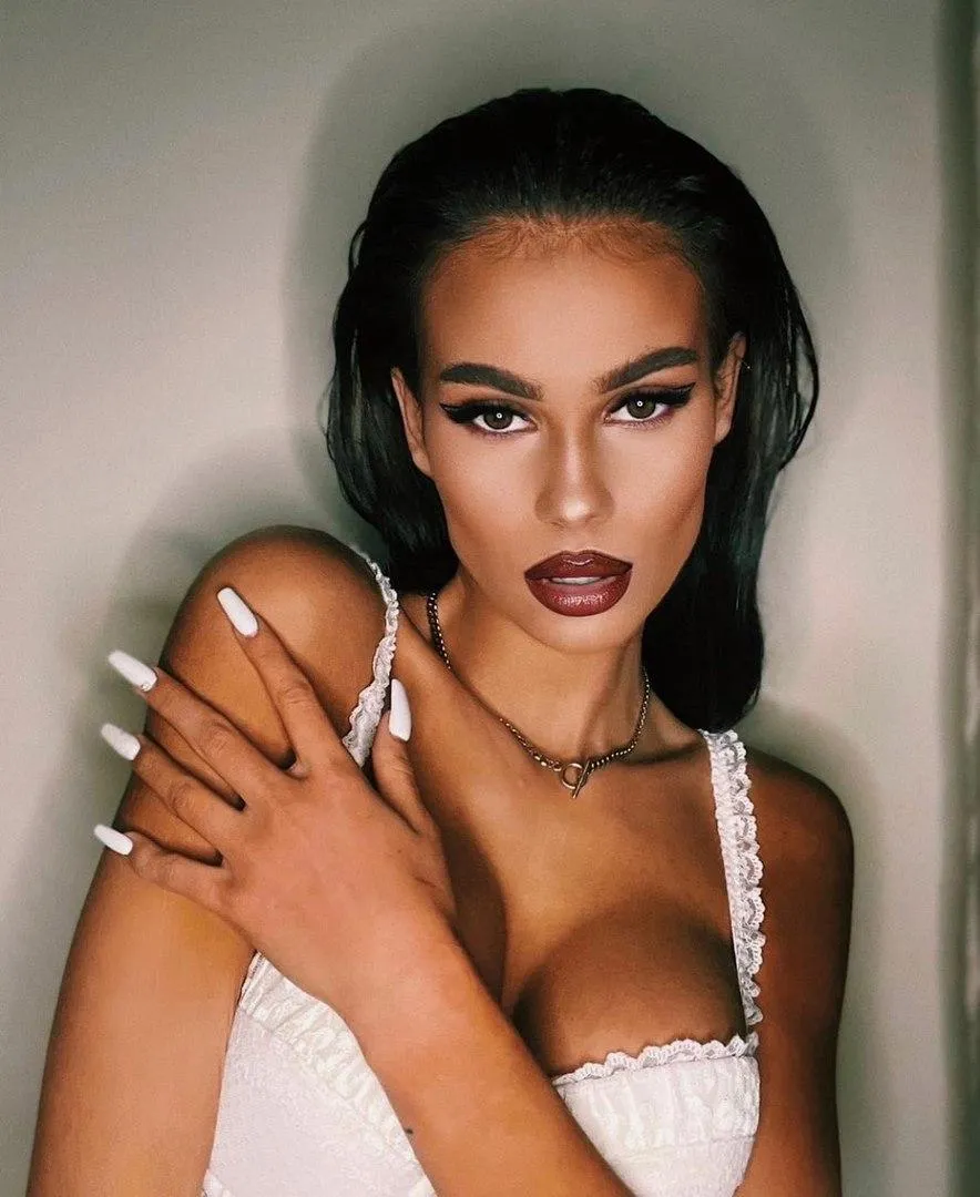 Glamorous Close Up of a Woman Holding a White Dress Strap