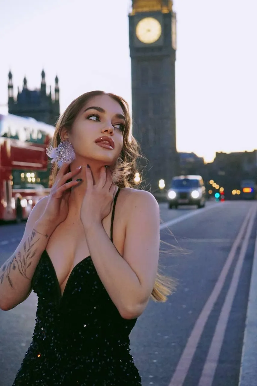 Glamorous woman posing near Big Ben in a sparkling dress