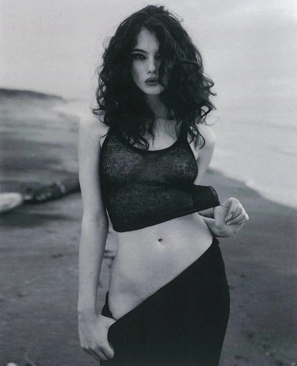 Grayscale Image of a Woman Standing Near the Beach Wallpaper