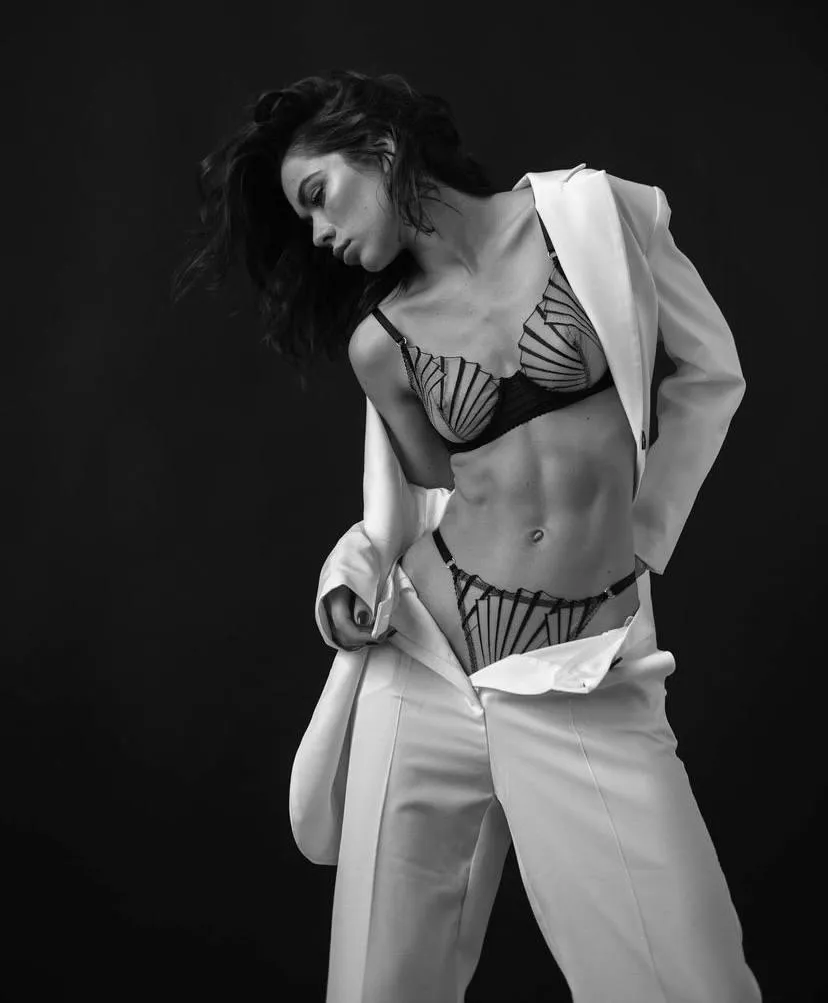 Hot young woman in a white outfit revealing her bikini