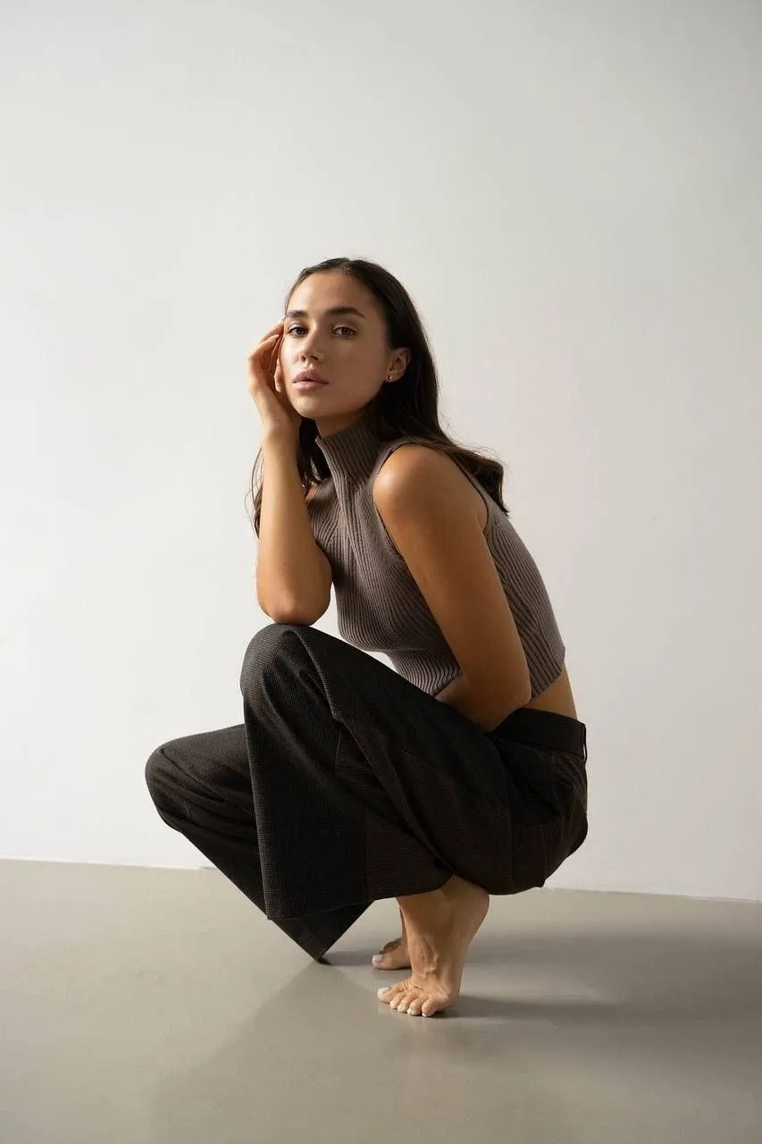 Minimalist fashion look with a sleeveless top and wide pants