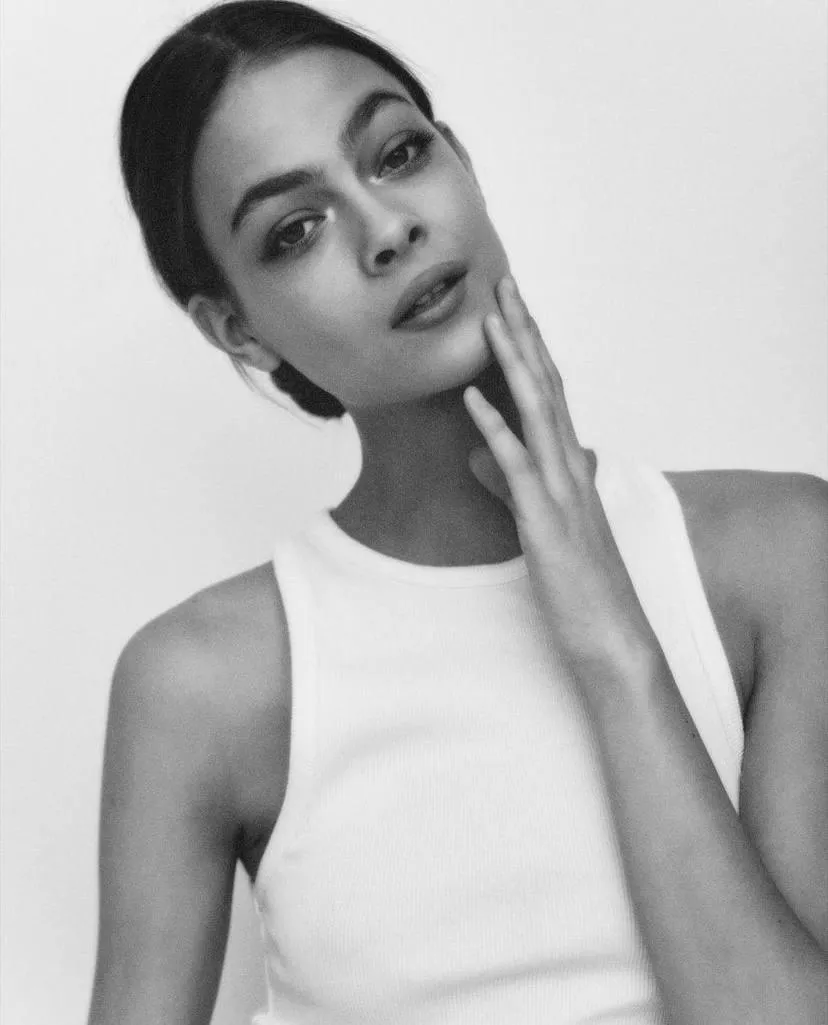 Minimalist portrait of a woman in a sleeveless white top