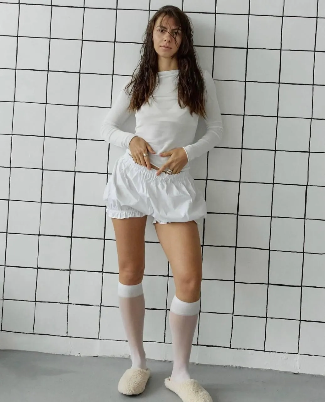 Model in a White Oversized Shirt Posing in a Tiled Room