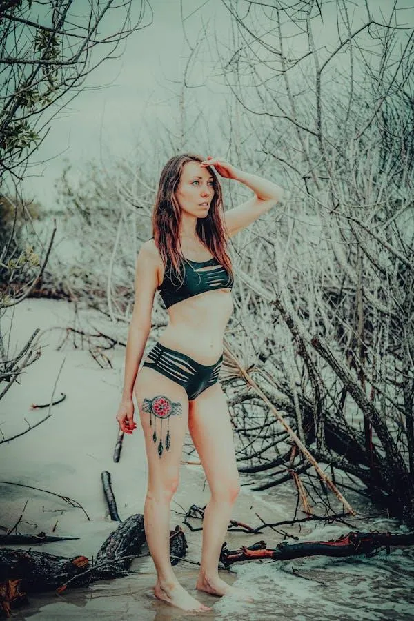 Model in a Winter Scene Posing Confidently with a Hand Up