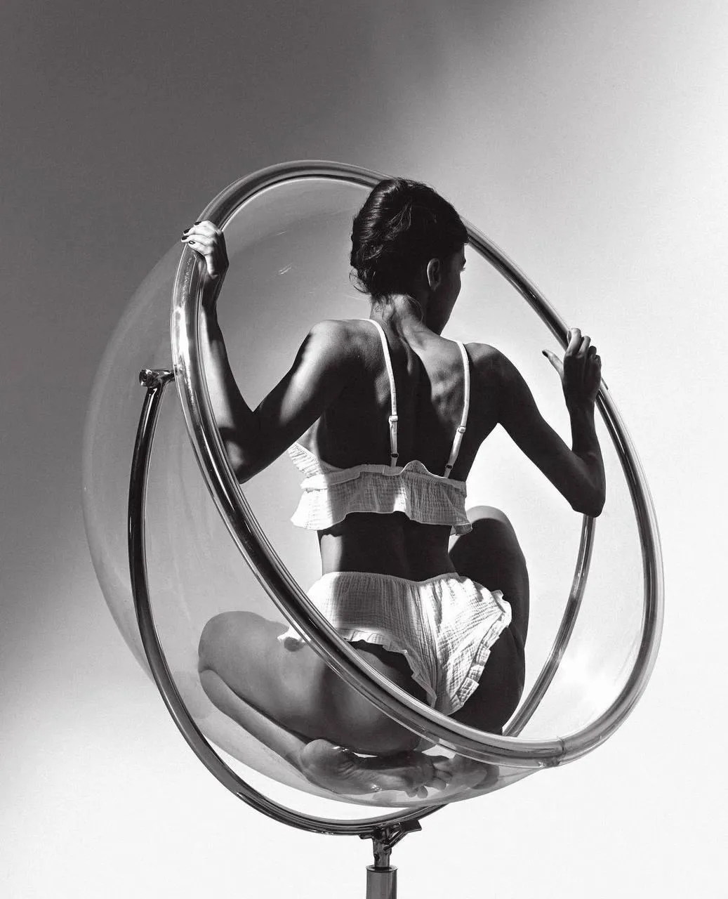 Model Seated in a Modern Artistic Chair Under a Spotlight