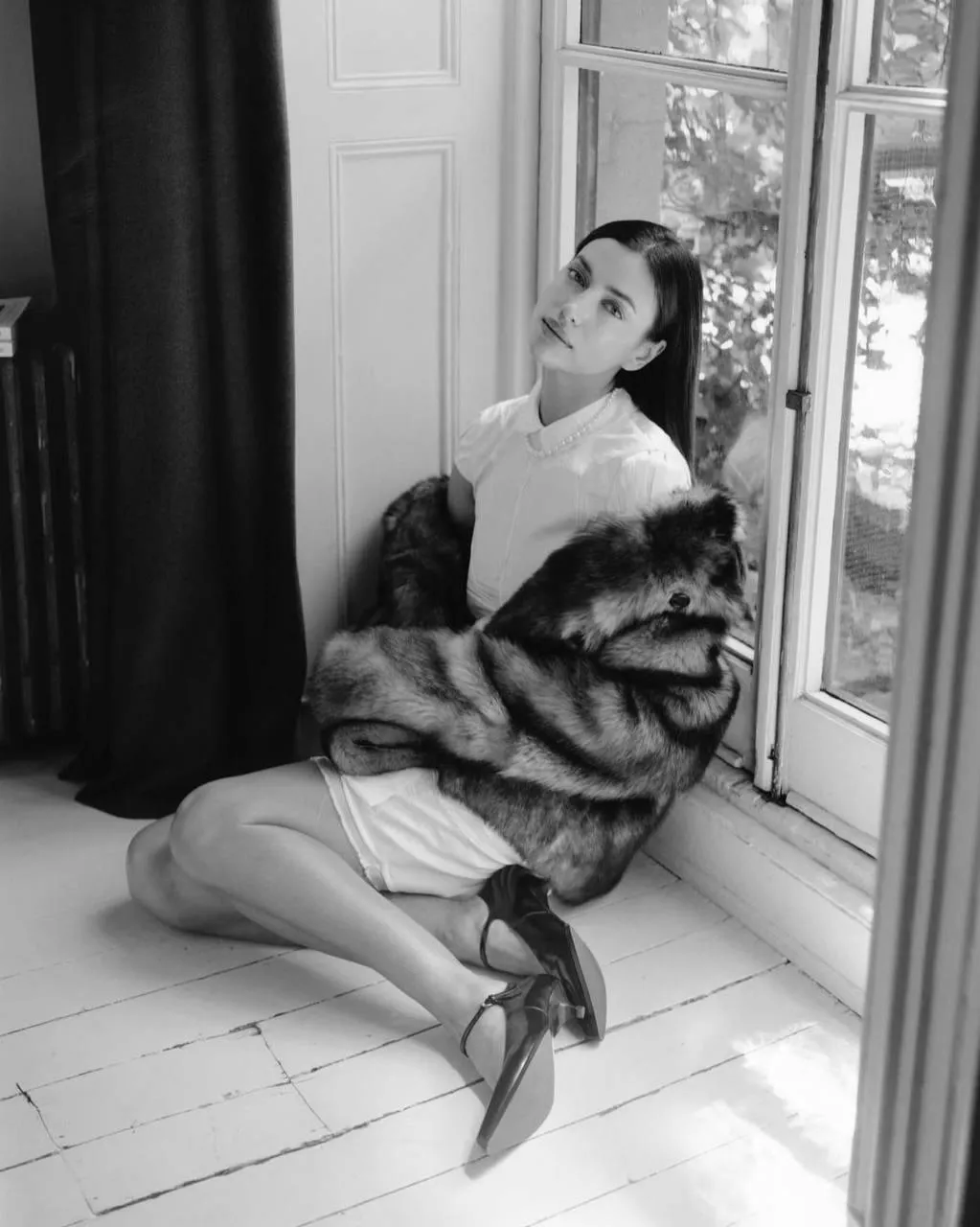 Model Seated Near the Window in Fur Coat in Black And White