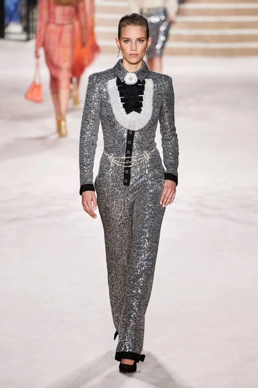 Model Walking on a Runway in Silver Embellished Suit Outfit