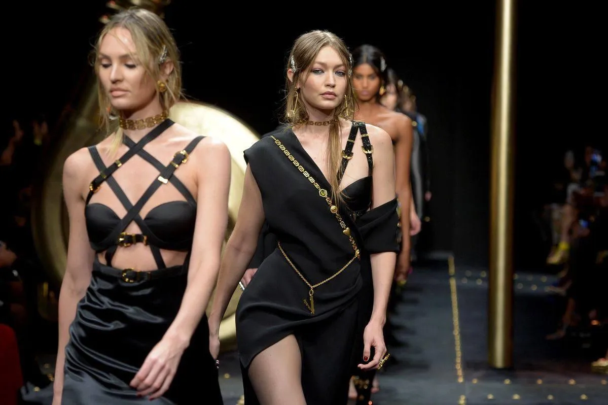 Models walking the runway in bold and edgy black outfits