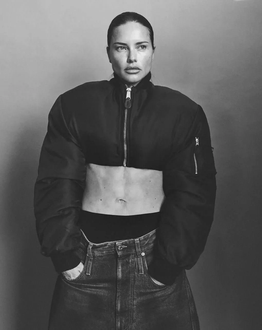 Monochrome image of a confident woman in a puffer jacket