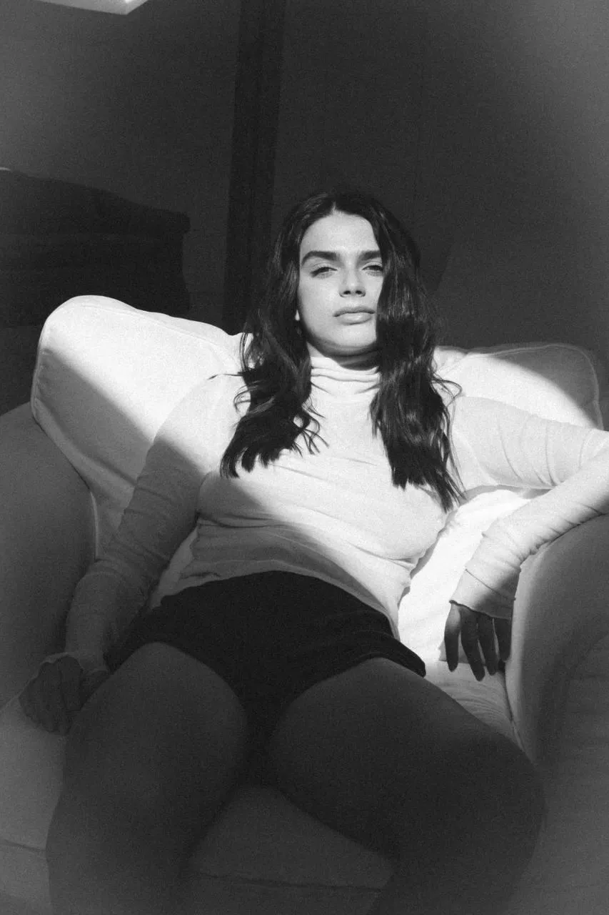 Monochrome Image of a Woman Resting on White Couch Wallpaper