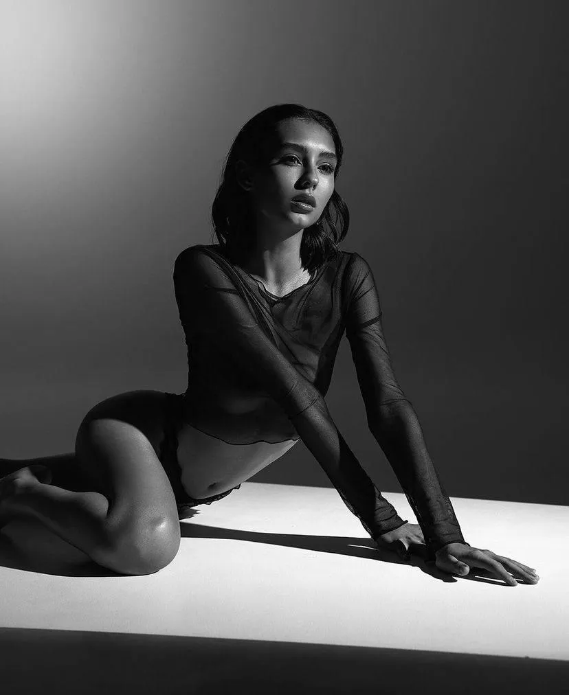 Monochrome of a woman wearing a black mesh full sleeve dress