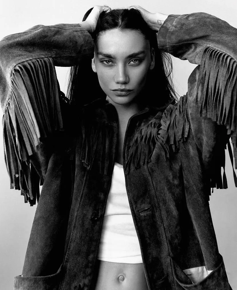 Monochrome Photo of a Woman in a Fringed Leather Jacket
