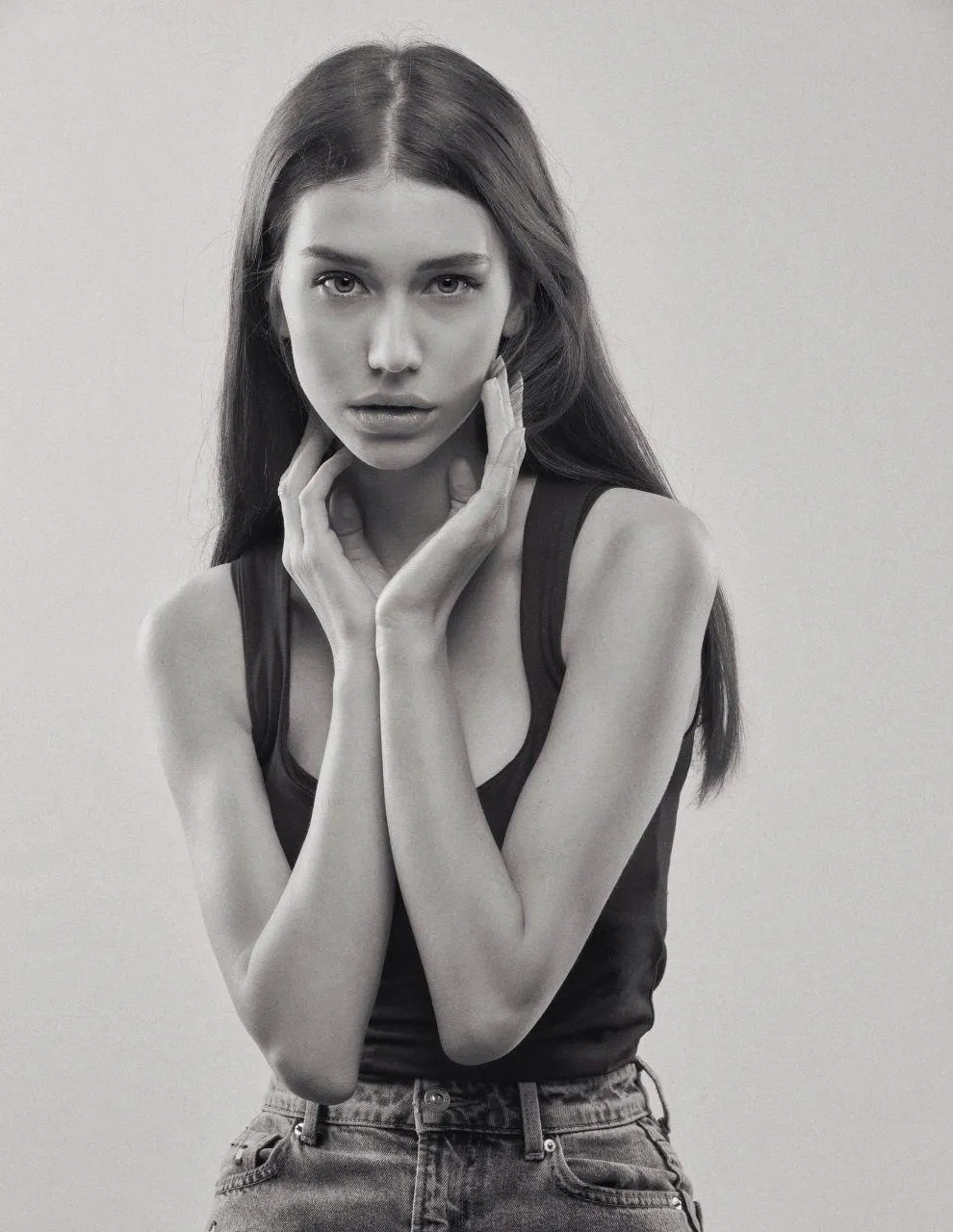 Monochrome Portrait of a Young Woman with Hands on Her Face