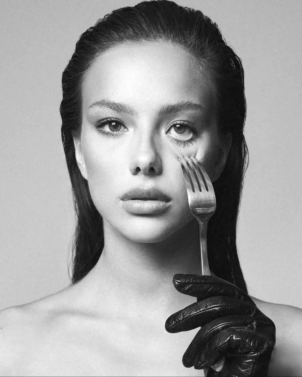 Monochrome Portrait with a Woman Holding Fork To Her Face