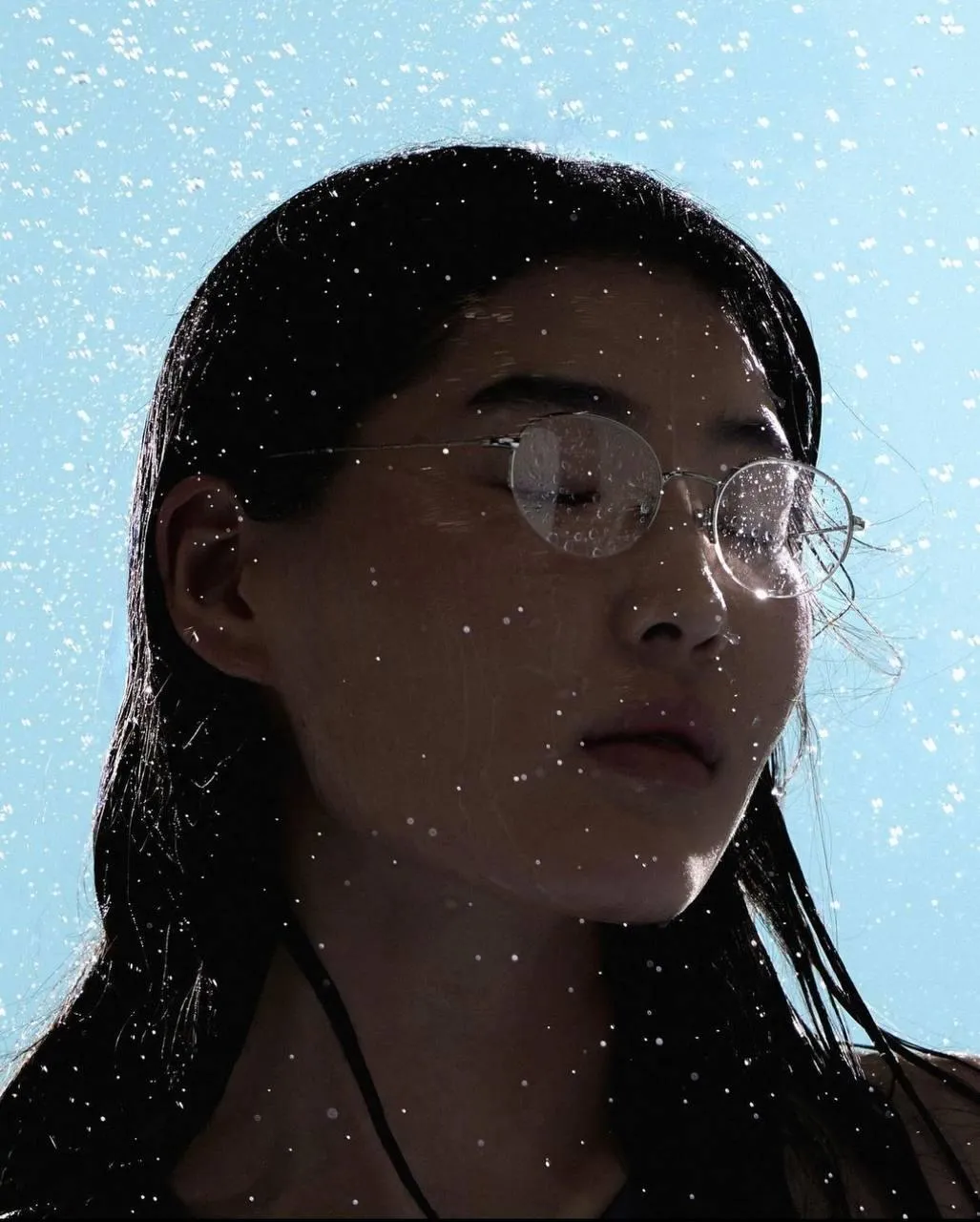 Moody Portrait of a Woman with Glasses And Raindrops Image