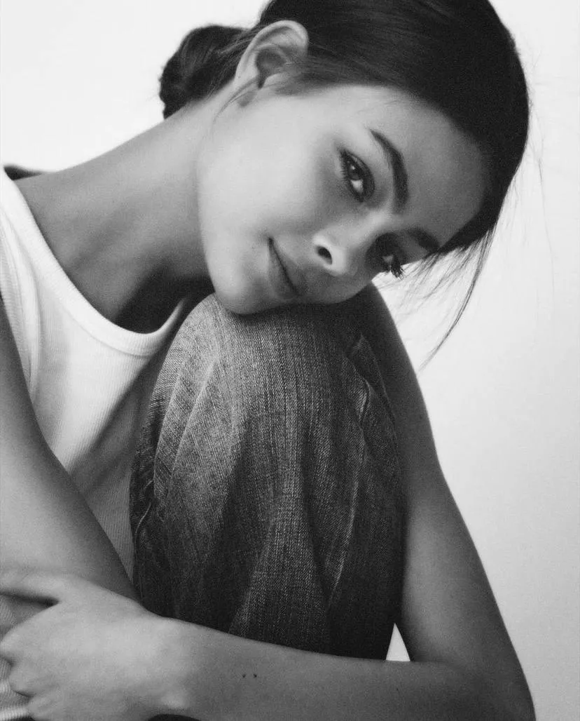 Pensive Woman Resting Head on Her Knee in Black And White