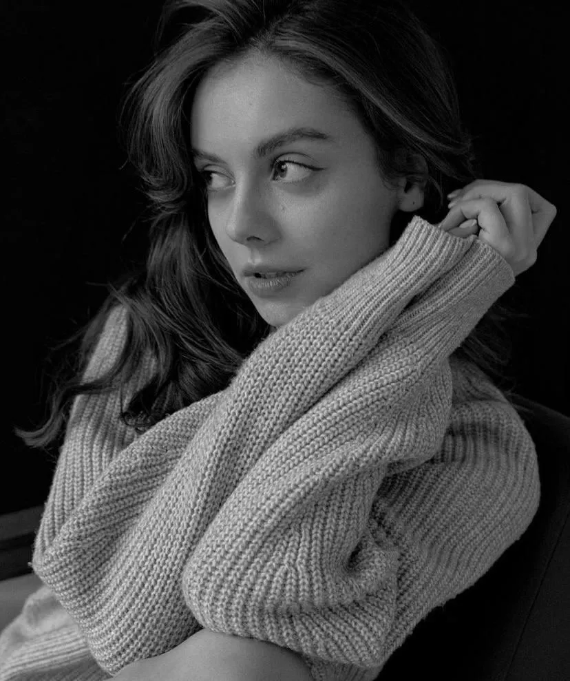 Pensive Woman Wrapped in a Warm Knitted Sweater Looking Away
