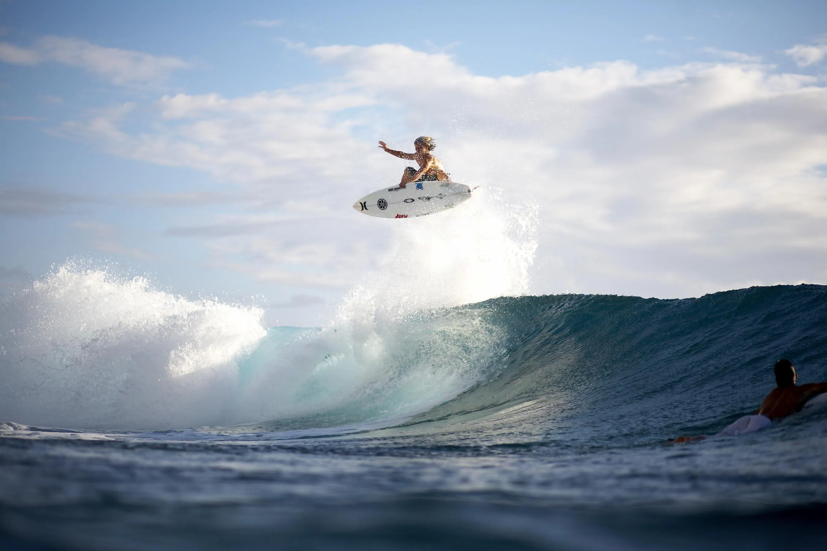 Person Riding a Jet Ski Jumping Over Waves on a Bright Day