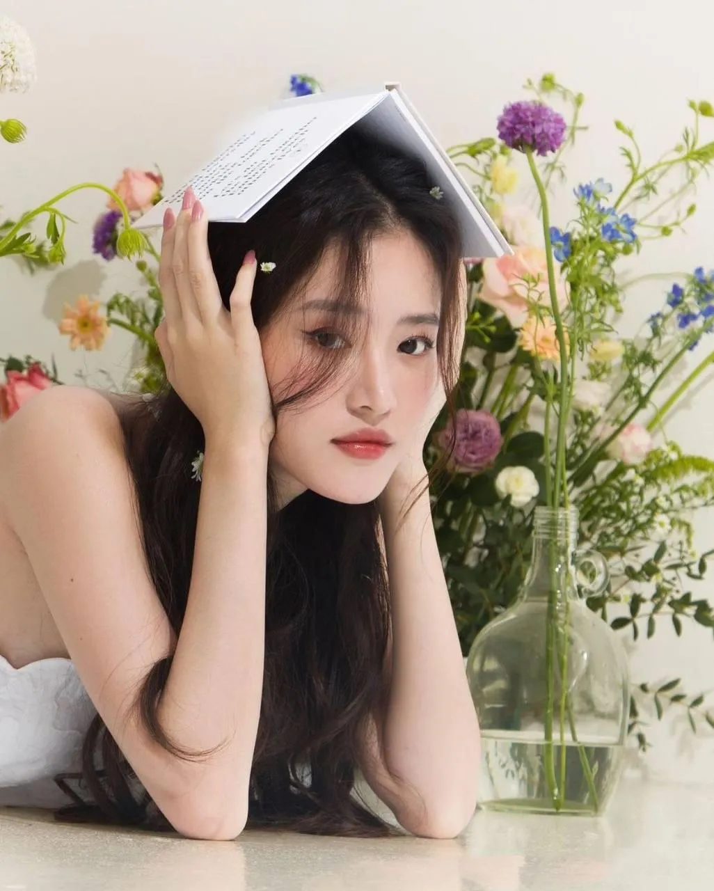 Playful Woman Resting Her Head on the Table with Flowers