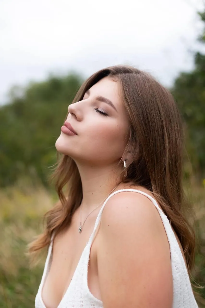 Portrait of a woman in a white dress eyes closed peaceful