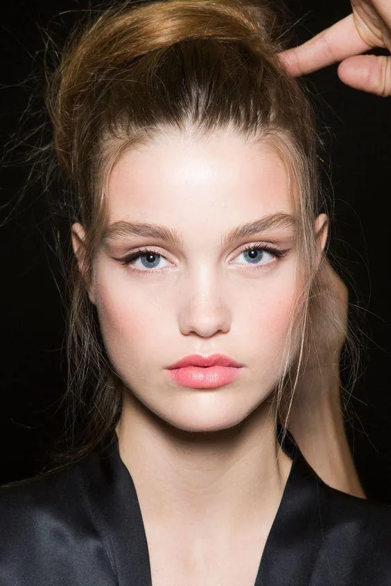Portrait of a young woman with sleek hair and a natural look