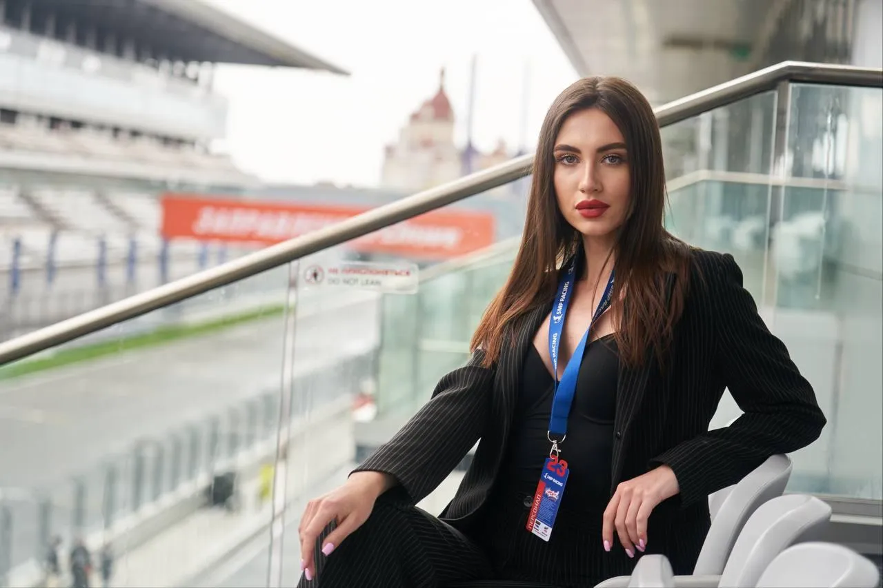 Professional Woman Sitting on a Balcony with a City View