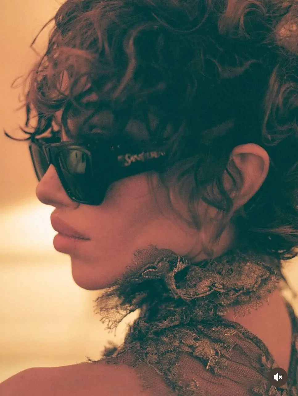 Profile of a Woman in Sunglasses Under Warm Light Wallpaper