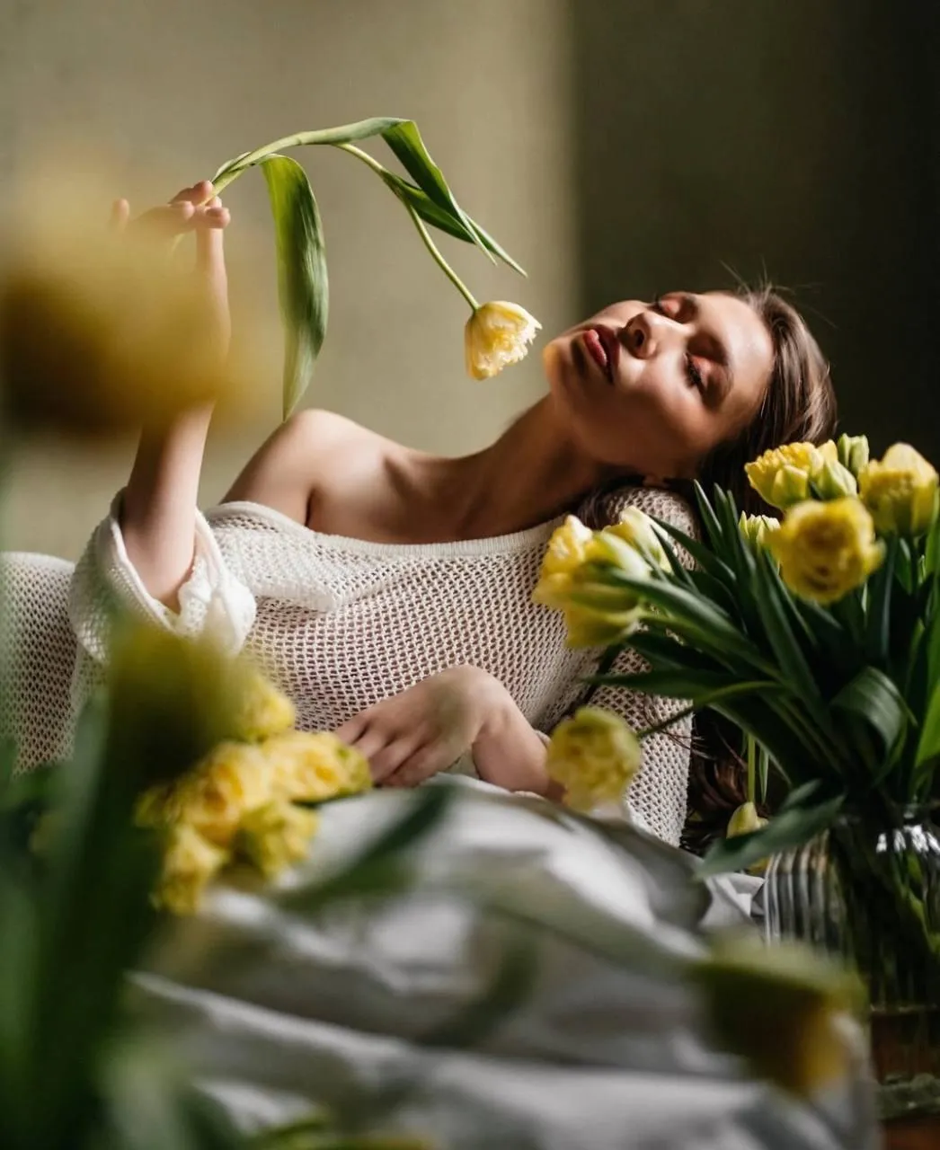 Relaxed Floral Scene with a Woman Posing in a Blooming Room