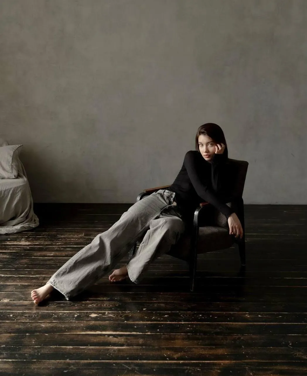 Relaxed Model Lounging on a Chair in Minimalist Room Setting