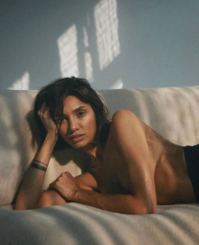 Relaxed woman lying on a couch in golden afternoon light