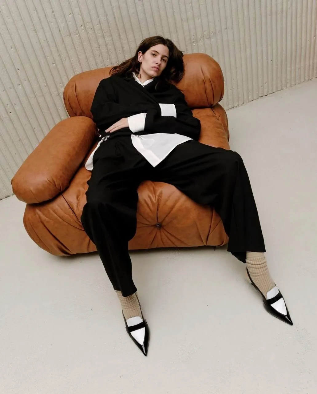 Relaxed Woman Sitting Comfortably on a Leather Chair Image
