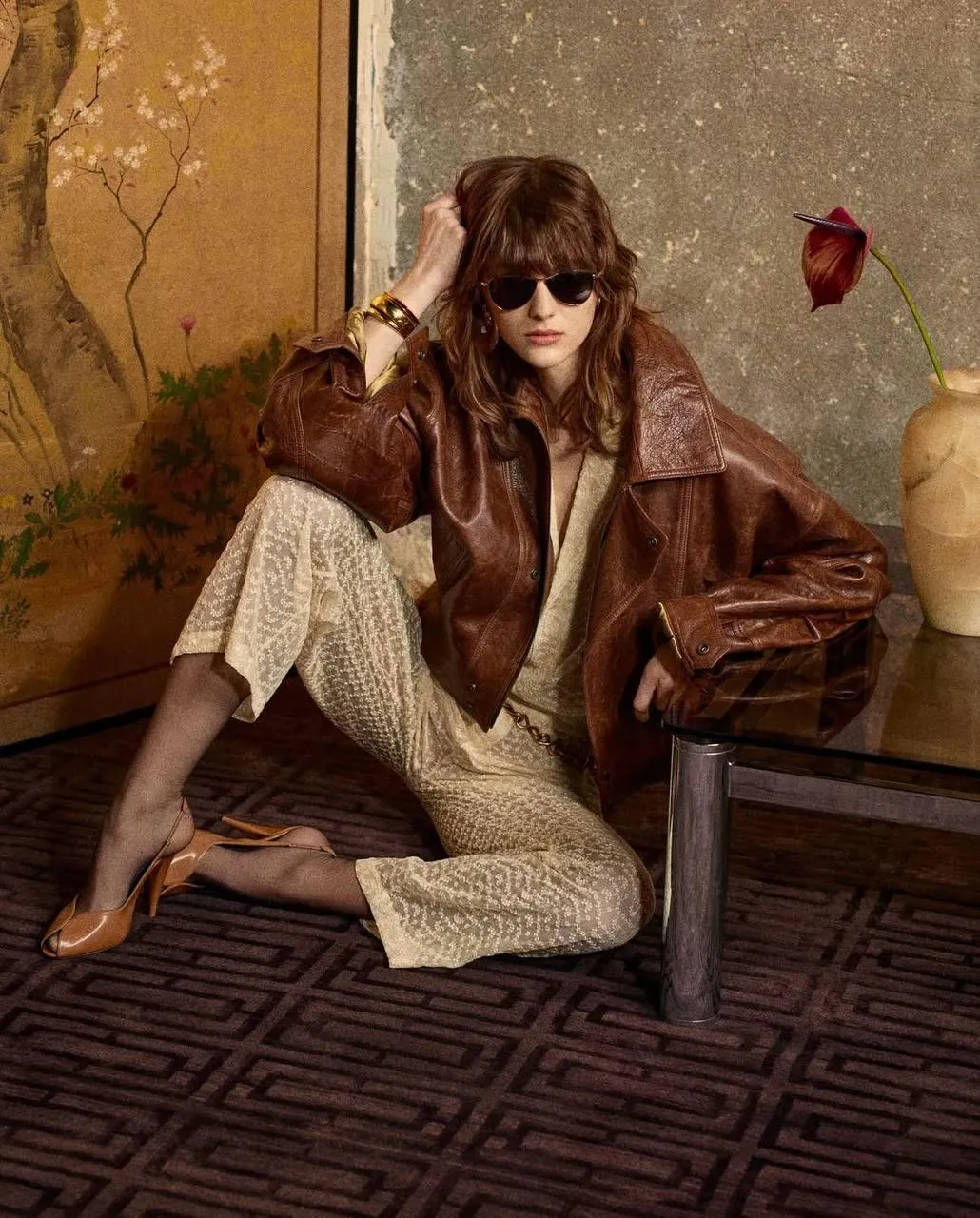 Retro Fashion Woman in a Fur Coat And Shades Sitting Indoors