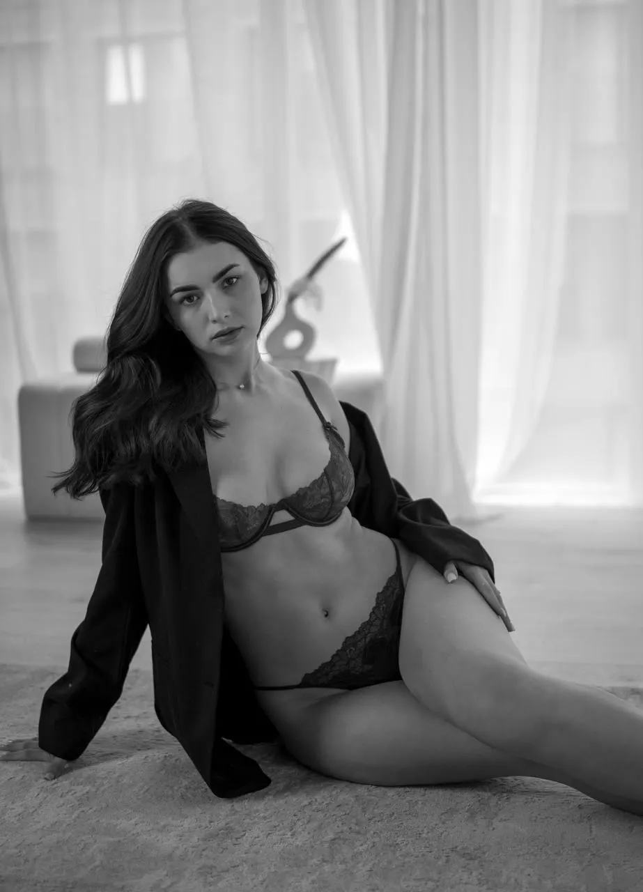 Sensual indoor portrait of a woman in black lingerie outfit
