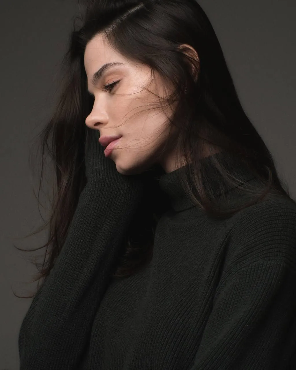 Serene Woman with Long Dark Hair in a Thoughtful Profile