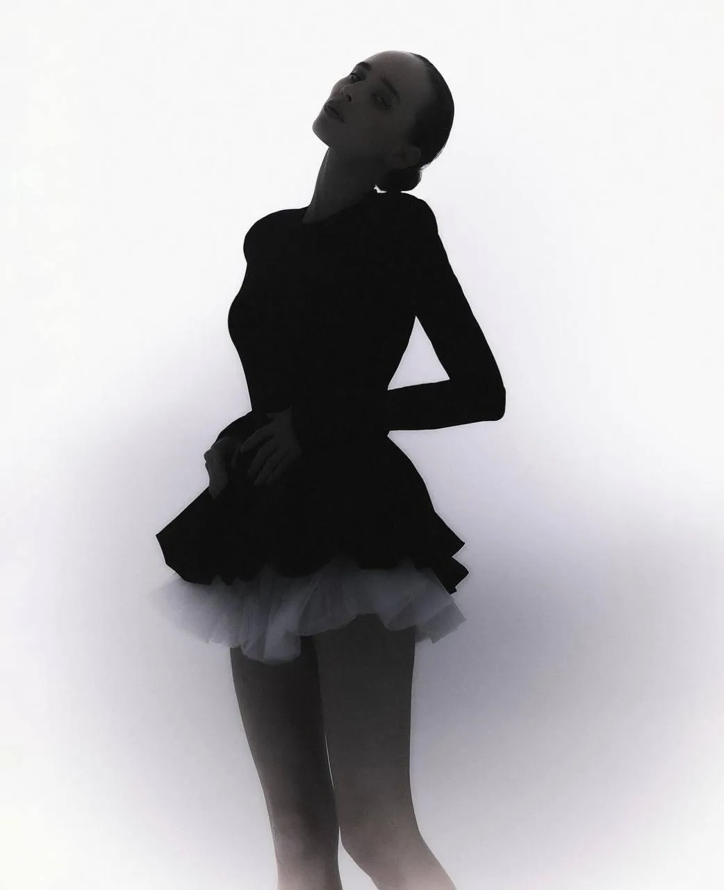 Silhouette of a woman in a black dress with a tulle skirt