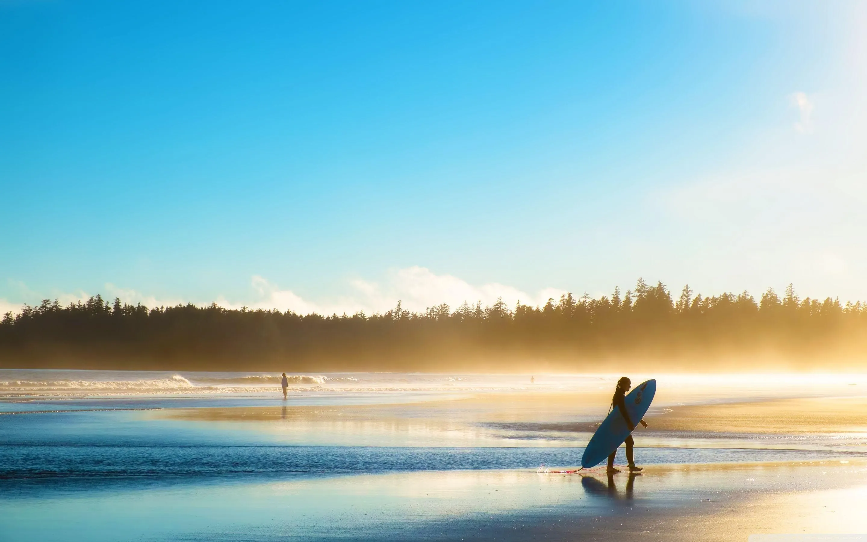 Silhouette of a Woman with a Surfboard Walking at Sunrise