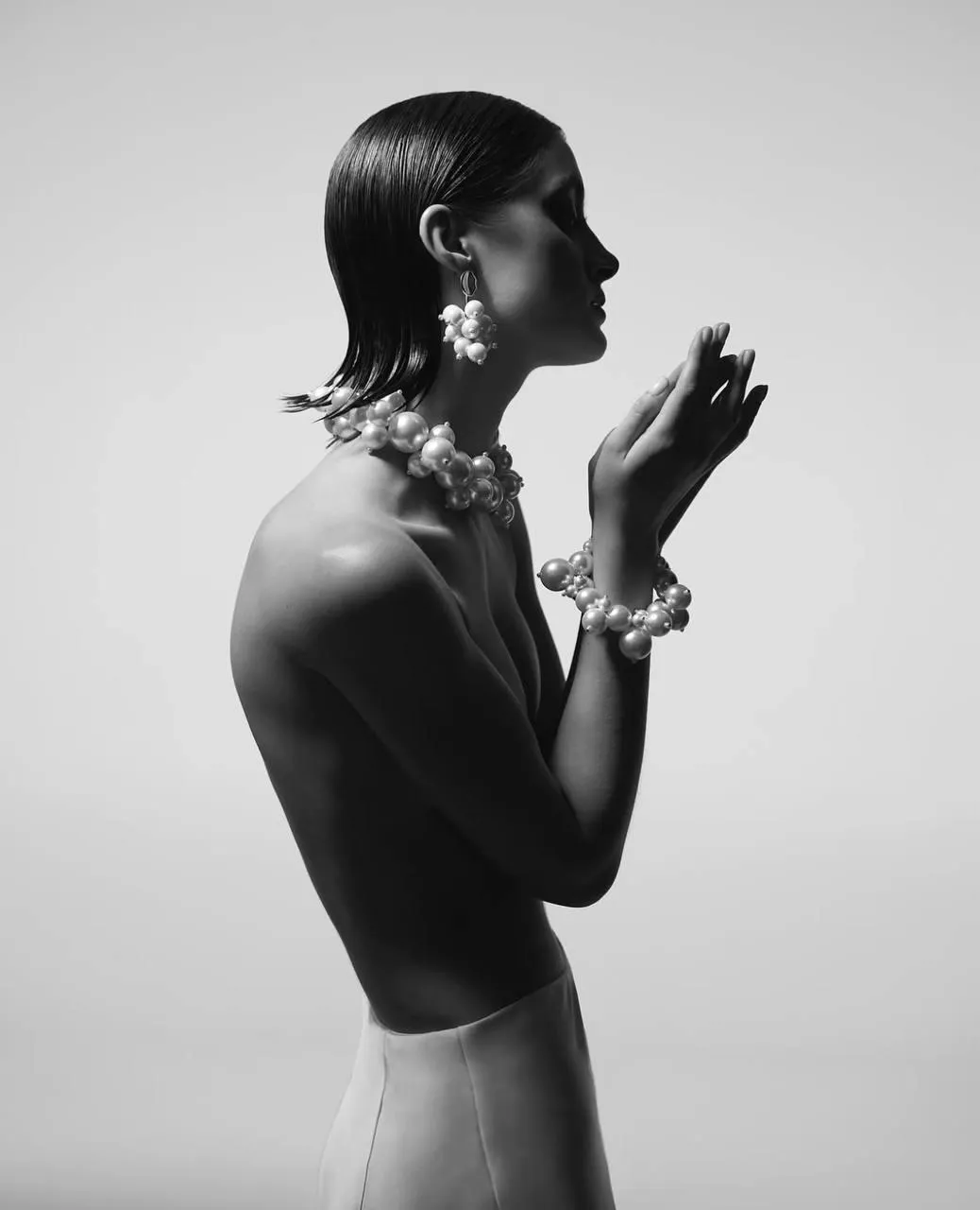 Skinny woman in a topless and wearing jewels with short hair